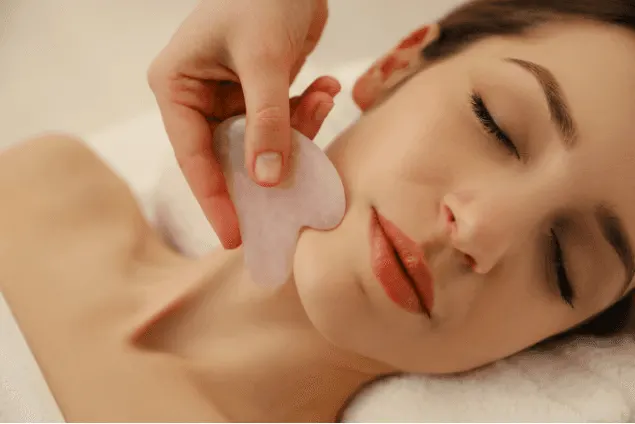 Gua sha facial with a rose quartz stone