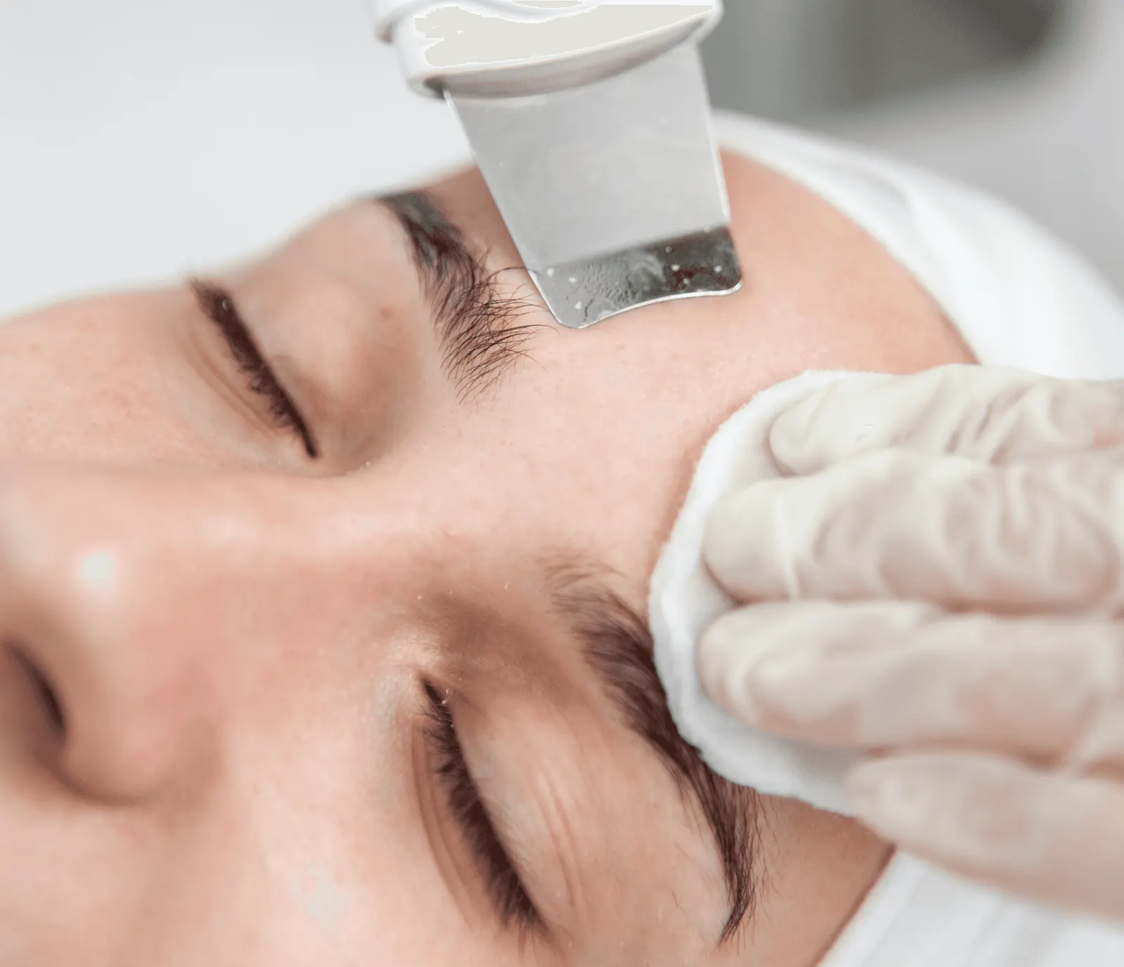 Ultrasonic skin scrubber used during a facial