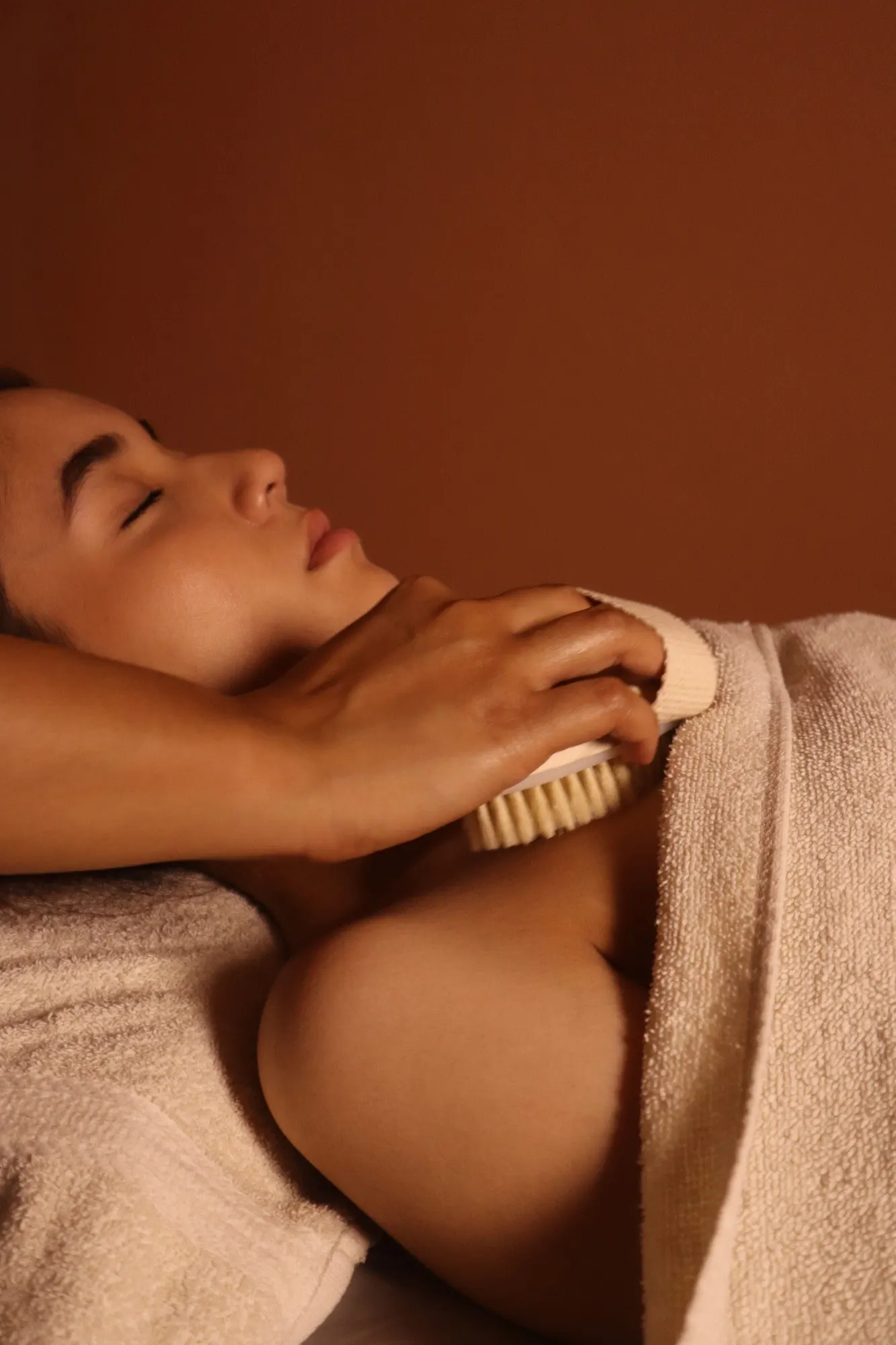 Dry brushing on a guest's shoulder